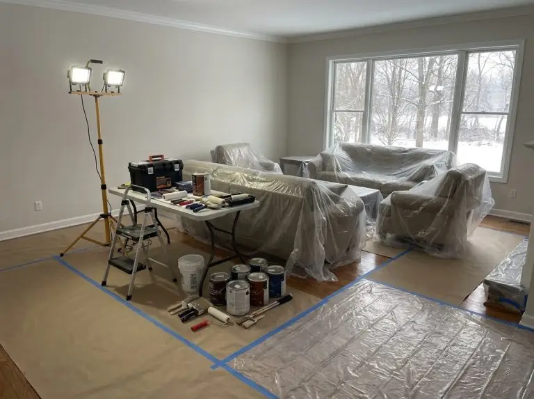 Well-organized winter renovation workspace showing professional preparation with protected floors and organized tools