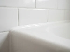 Close-up of a clean silicone caulk line sealing a bathroom corner