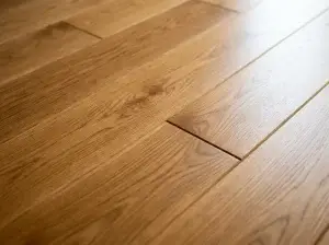 Close-up of a screw fastening floorboards to stop a squeak