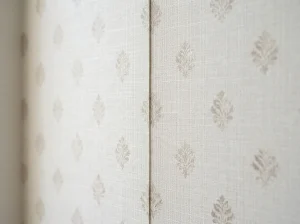 Close-up of wallpaper seam being aligned and pressed flat