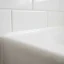Close-up of a clean silicone caulk line sealing a bathroom corner