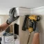 Handyman nailing crown molding into place at the ceiling line