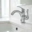 Close-up of a polished chrome faucet base sealed to the countertop