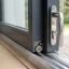 Close-up of a patio door roller and weather seal along the frame