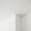 Close-up of a scraper removing popcorn texture from a drywall ceiling