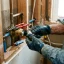 Handyman replacing a shower valve cartridge behind the wall plate