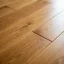 Close-up of a screw fastening floorboards to stop a squeak