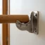 Close-up of a baluster bracket secured to a stair handrail
