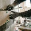 Handyman setting ceramic tiles into mortar with a notched trowel